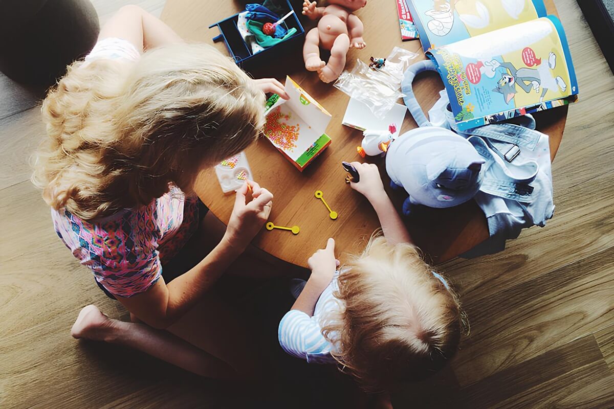 Mother and child playing with toys as part of ABA therapy