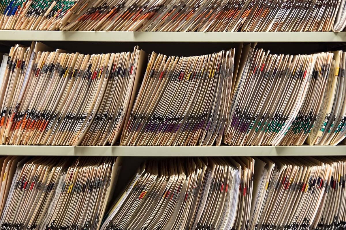 folders tightly lined up in a shelf