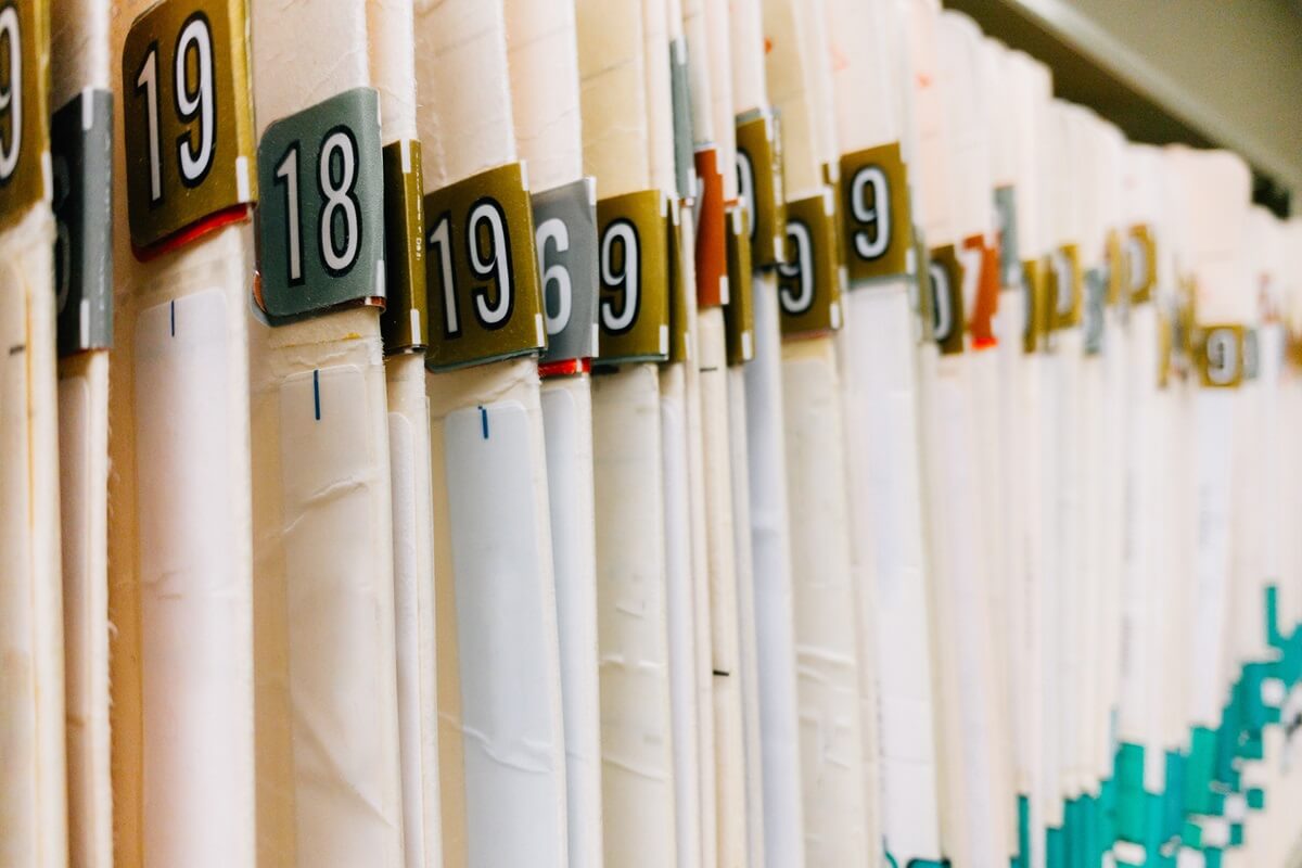 ABA paper patient chart folders with numbers on shelf