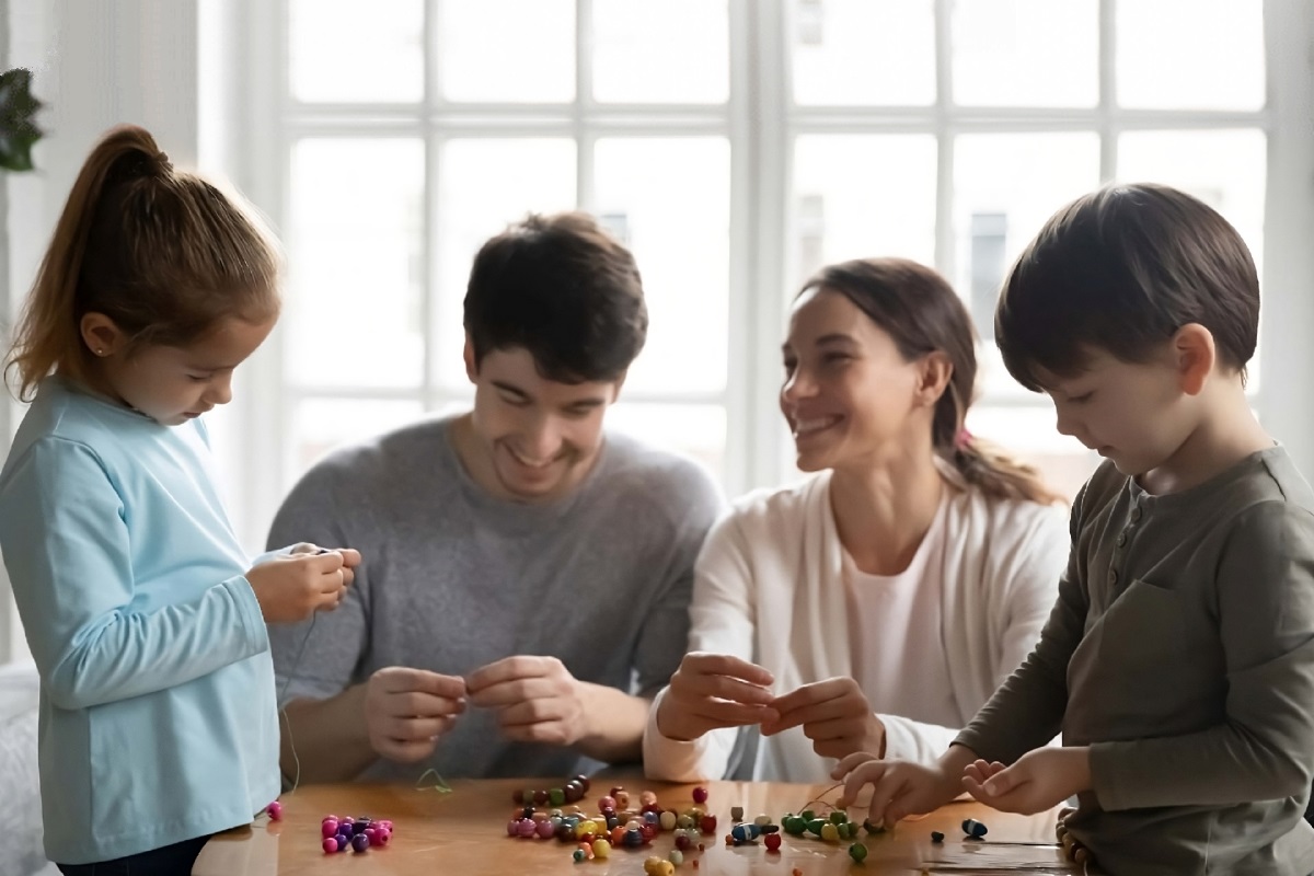 Parents engaging with their children around table smiling together