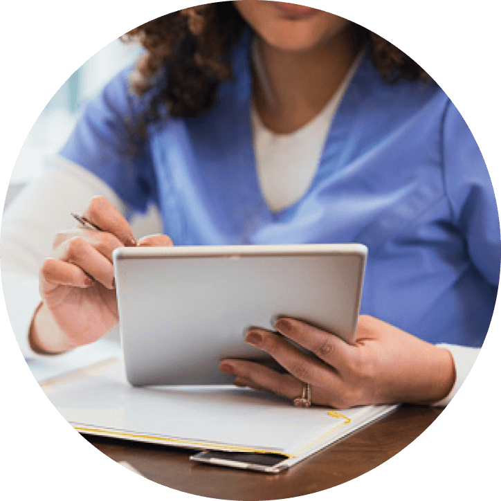 Woman in medical uniform looking at her tablet