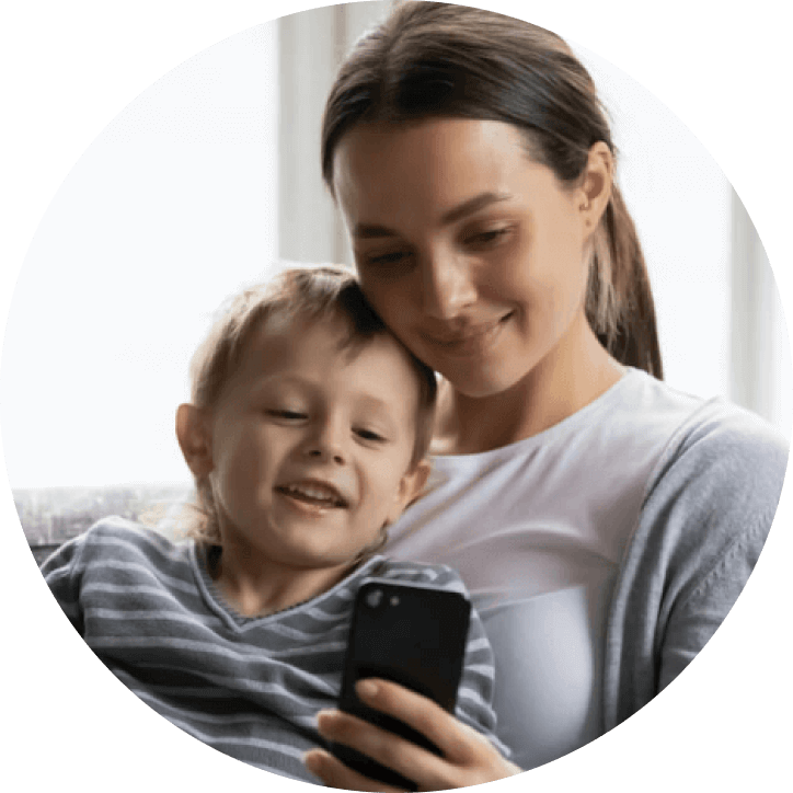 Mother and son smiling at mobile phone