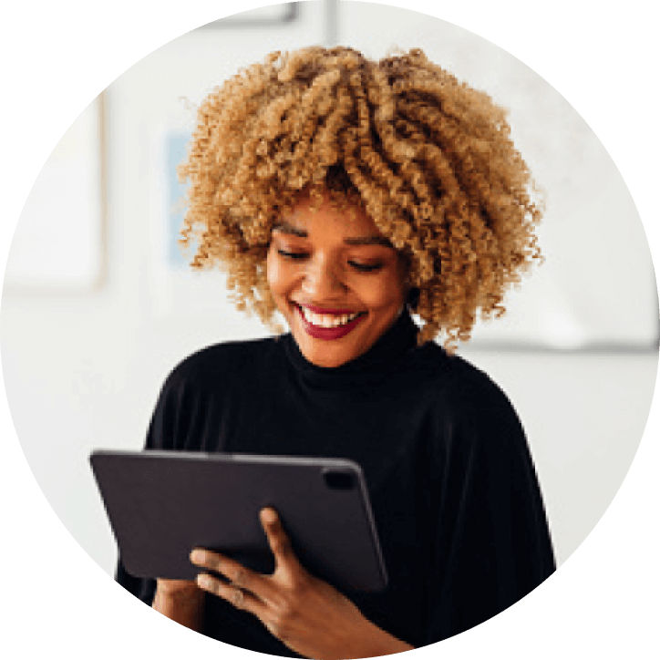 African American women smiling at tablet