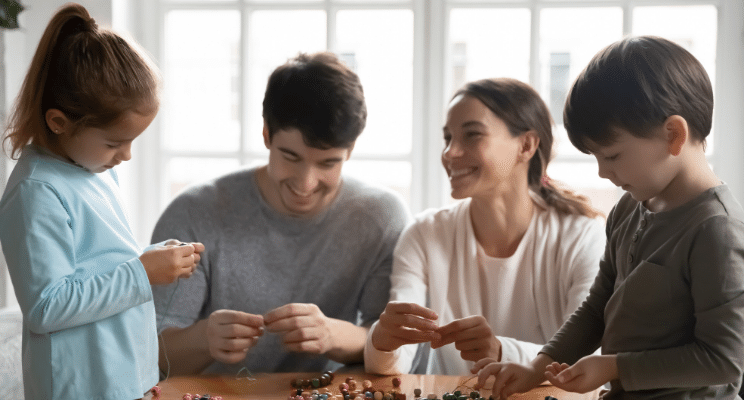 Family around table smiling together