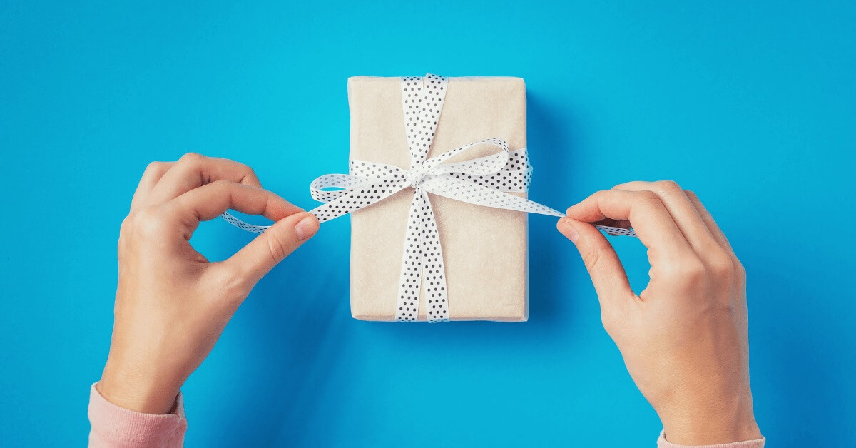 Person wrapping a gift