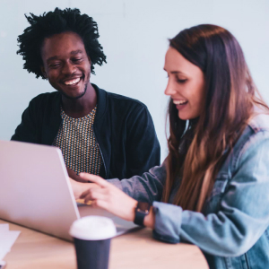 Woman and Man smiling while working on the laptop