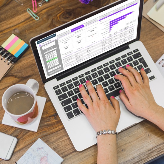 Hands using laptop with Rethink Analytics by RethinkBH
