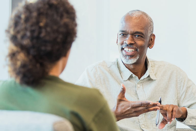 Female ABA Provider listens to older African American male during session