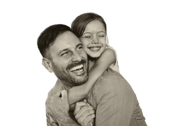 A smiling father and daughter sharing a happy embrace.